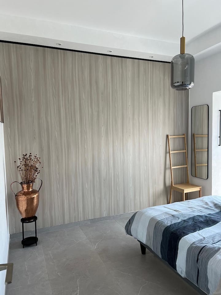 Discover comfort and style in our inviting second bedroom, designed with your relaxation in mind. Featuring a cozy queen-sized bed dressed in luxurious linens, it offers a tranquil retreat with soft lighting to ensure a peaceful night's sleep.