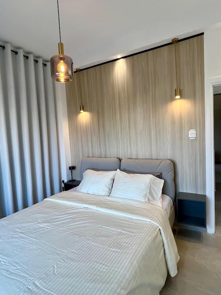 Enter our luxurious master bedroom sanctuary, where comfort and sophistication intertwine seamlessly. Sink into the indulgent queen-sized bed adorned with premium linens, surrounded by soft lighting that sets the mood for relaxation.