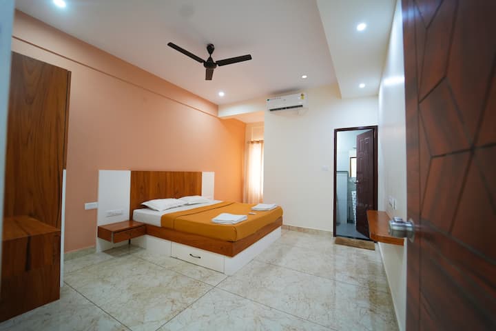 “Comfortable AC bedroom with fresh linen and warm lighting.”