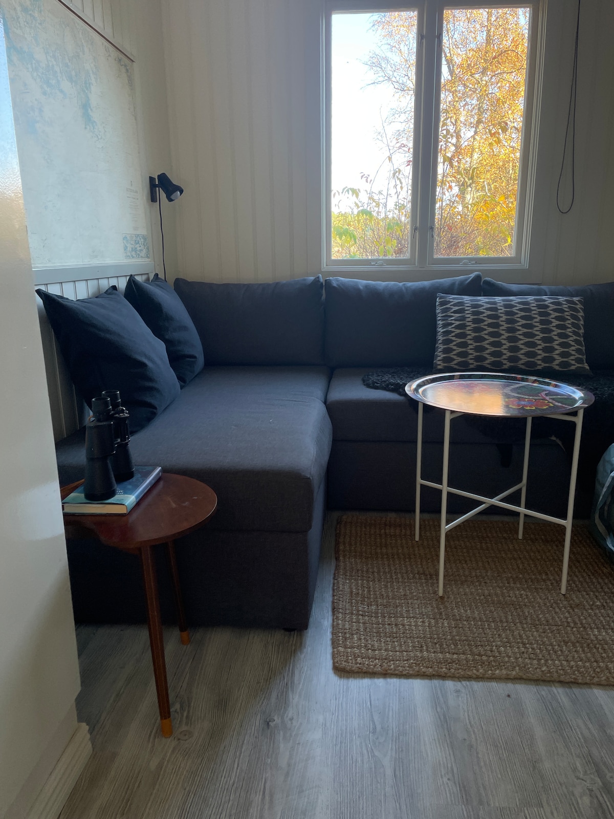 Little house, living room with TV & sofa bed with view to the sea. 