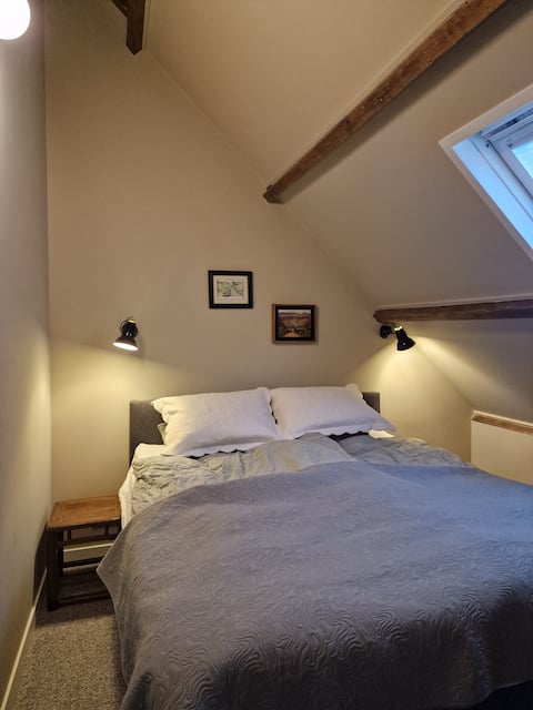Stylish attic appartment, bed and bath.