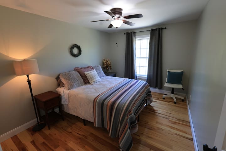 Bedroom 2 here.  Ceiling fan above and bathroom right across the hallway. Large closet shall you need it.