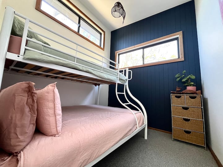 The second bedroom offers a double bed and single bunk bed, providing a versatile and cozy space for family or friends.
