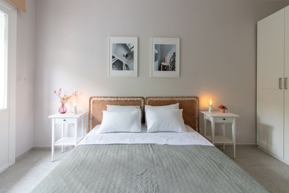 Cozy bedroom with rattan headboard and soft, calming decor