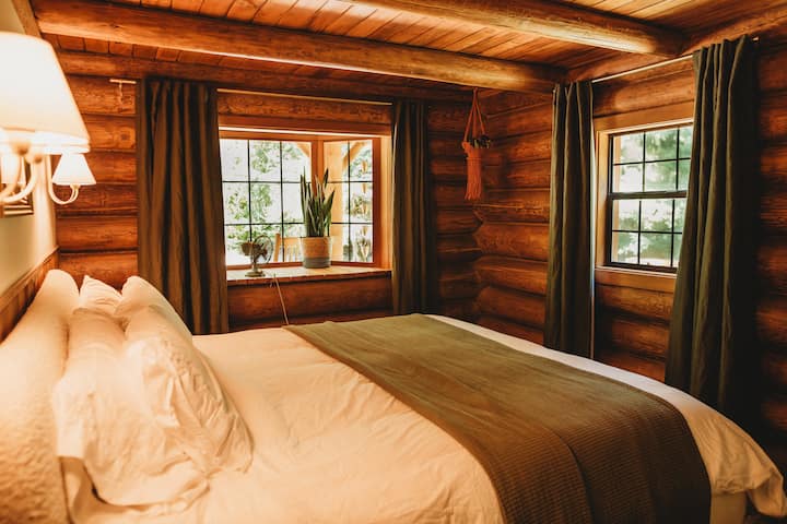 The main floor primary bedroom holds a king bed and lovely bay window!