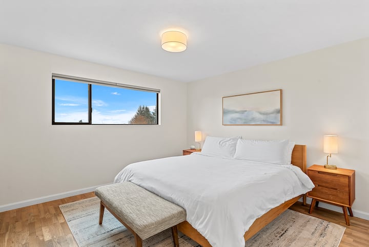 Spacious king bedroom located upstairs. This bedroom features sweeping mountain views, full length mirror, sound machine/alarm clock, and vintage low dresser to conveniently place suitcases on.