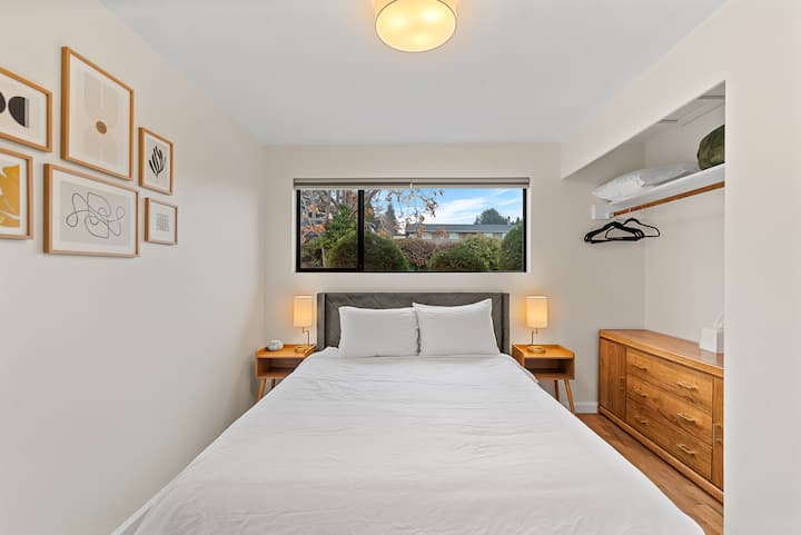 Queen bed located upstairs. This bedroom features a makeup vanity, sound machine/alarm clock, full length mirror, and a vintage low dresser to conveniently place suitcases on.