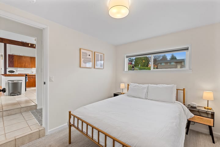 Third upstairs bedroom with queen bed. This bedroom has its own climate control, sound machine/alarm clock, full length mirror, and vintage low dresser to place luggage.