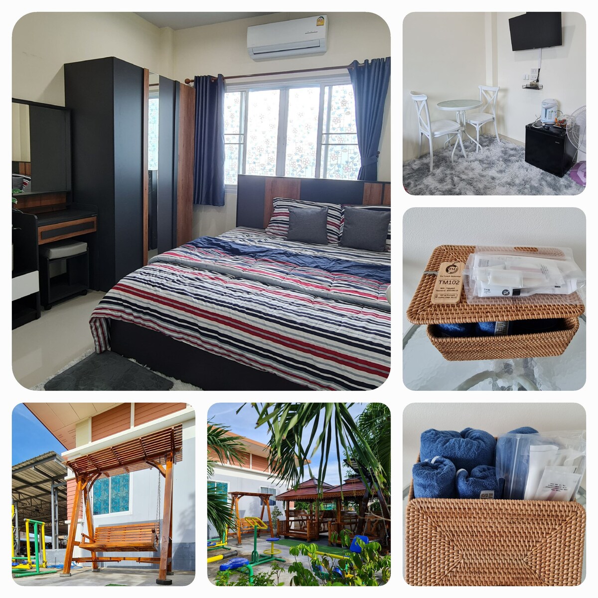 A bright and airy bedroom features a spacious bed with striped bedding, complemented by dark curtains and a dressing table. A small seating area includes two modern chairs and a table. Outside, a swing chair adds a relaxed touch to the lush green garden.