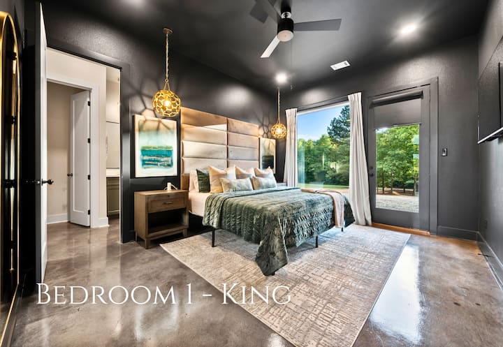 The spacious king-sized bed, featuring an elegant, padded headboard, is the centerpiece of this luxurious bedroom.