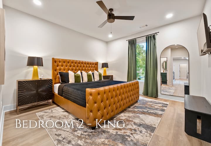 The king-sized bed, with its plush, tufted headboard, promises a comfortable and luxurious night's sleep.