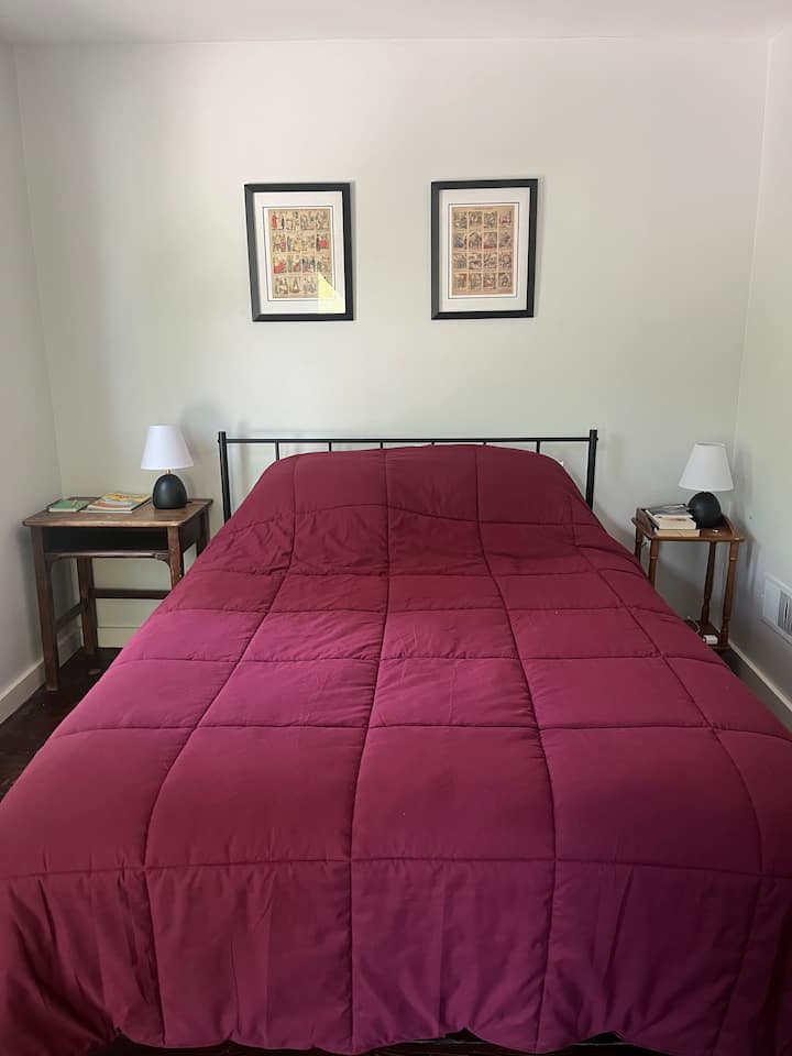 Bedroom with queen bed; dresser; closet space; Peloton and gym equipment (light weights, yoga mat, bands, foam roller). Facing quiet street (dead end, limited traffic). All bedrooms have blackout curtains.