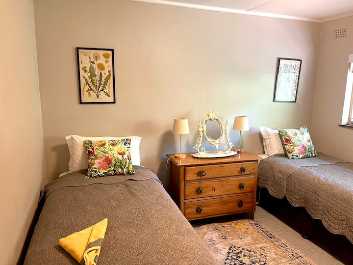 The Botanical Room- room three in the main house with two single beds and blockout blinds. 