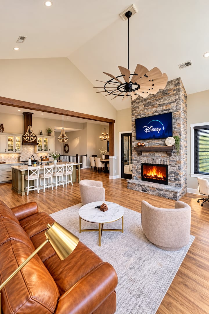 Relax and unwind in our spacious, open-concept living room featuring soaring ceilings, a cozy LED fireplace, and a large Smart TV. Perfect for family gatherings, movie nights, or simply enjoying quality time together!
.
