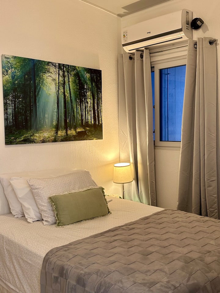 Private room with air conditioning, blackout curtains, and a comfortable bed to rest after a day of work, sightseeing, or errands in the city.