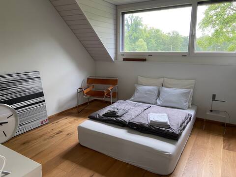 Bedroom & shared bathroom in a top-floor apartment