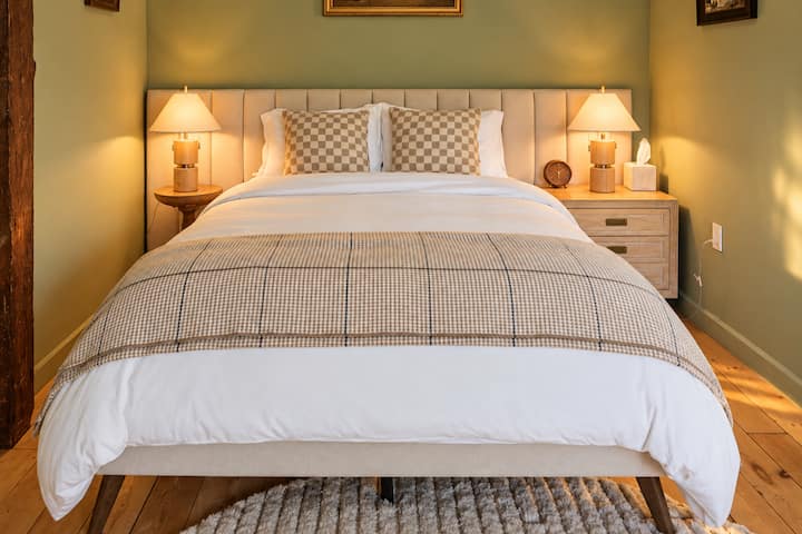 Clean design and warm tones in this queen bedroom.