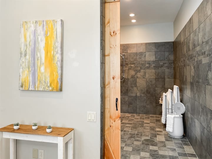 Escape to a serene retreat where accessibility meets luxury. Our ADA-compliant bathroom offers a safe, rejuvenating experience with a towel warmer, perfect for relaxation and recovery!