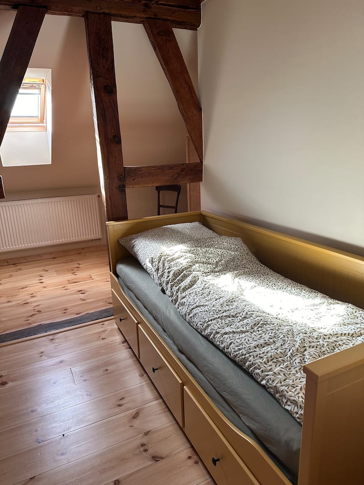 The yellow bed can be pulled out to become a double bed.