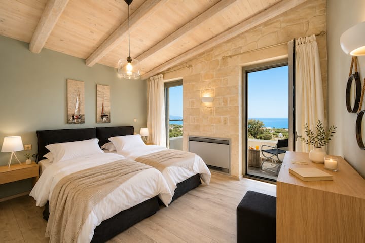 Upper Floor - Bedroom 3 with two single beds (convertible into a king-size bed upon request), en-suite bathroom and private balcony offering breathtaking sea and countryside views.