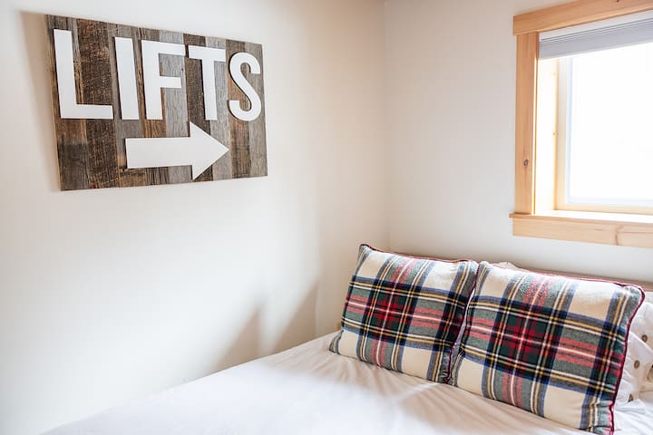 Bedroom 2 has a queen bed, blackout shades and alarm clock