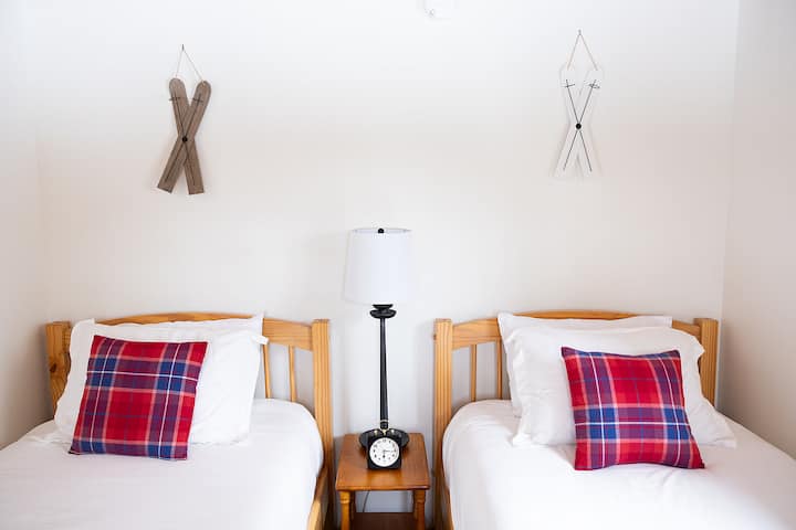 Bedroom 3 features two twin beds, black out shades and alarm clock