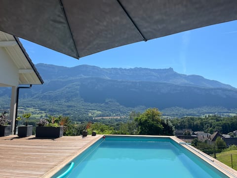 House with pool near lake and mountains