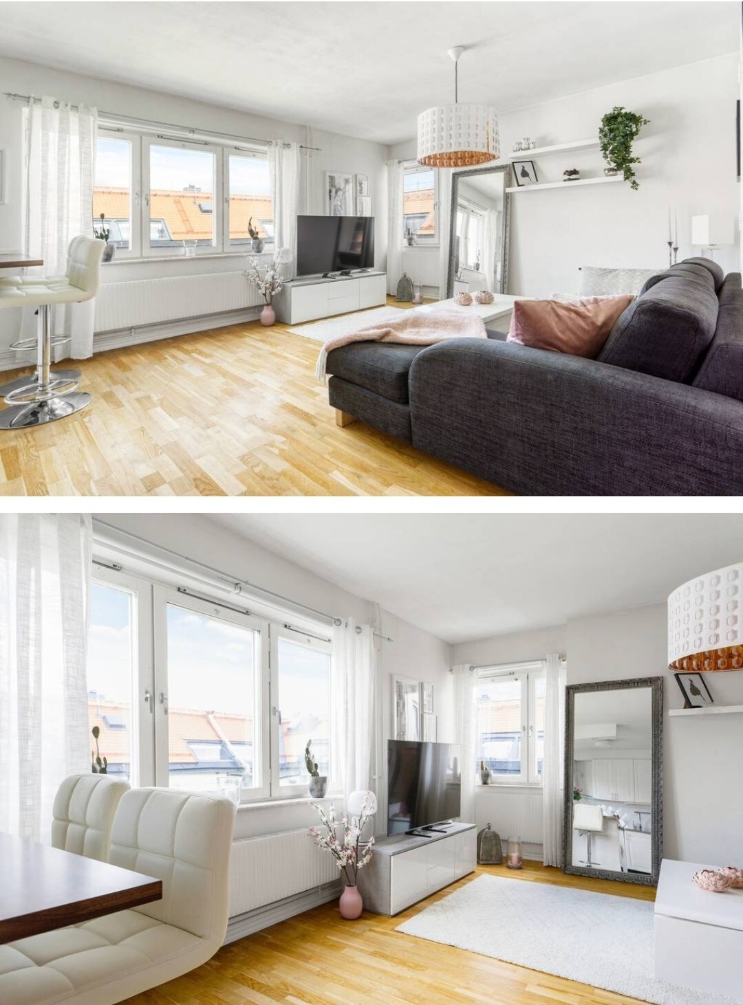 A cozy living space is depicted with light wood flooring and large windows allowing natural light. A large gray couch is seen next to a television mounted on a white entertainment unit. A dining area with a white table and chairs is visible, enhancing the room's functionality.