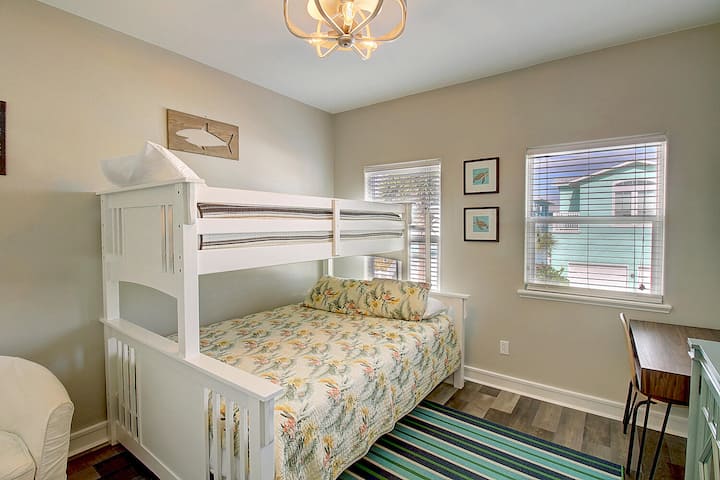 Your kids will love this cheerful bunk room with tropical-themed bedding and bright coastal artwork.