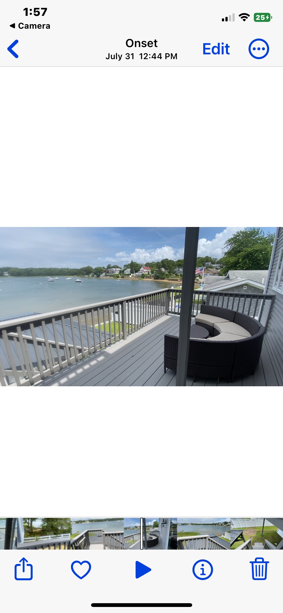 A spacious deck overlooks Broad Cove, featuring a curved seating arrangement that provides ample space for relaxation. The view captures the serene water and surrounding scenery, while gray weather-resistant materials complement the outdoor setting.