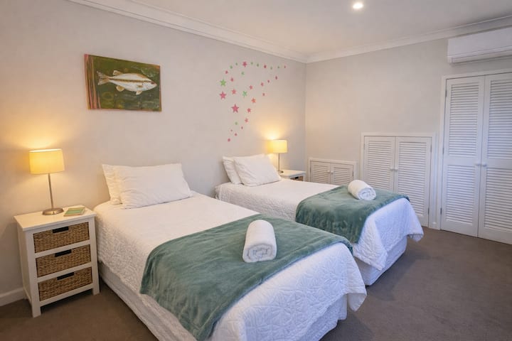 Sunny twin bedroom with cosy bedding - perfect for families or friends travelling together