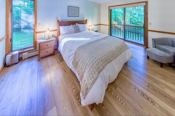 Upstairs Master Bedroom with access to back deck and window with view of side yard.