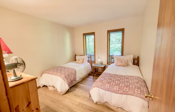 Upstairs additional bedroom with 2 twin beds and view of deck and backyard.