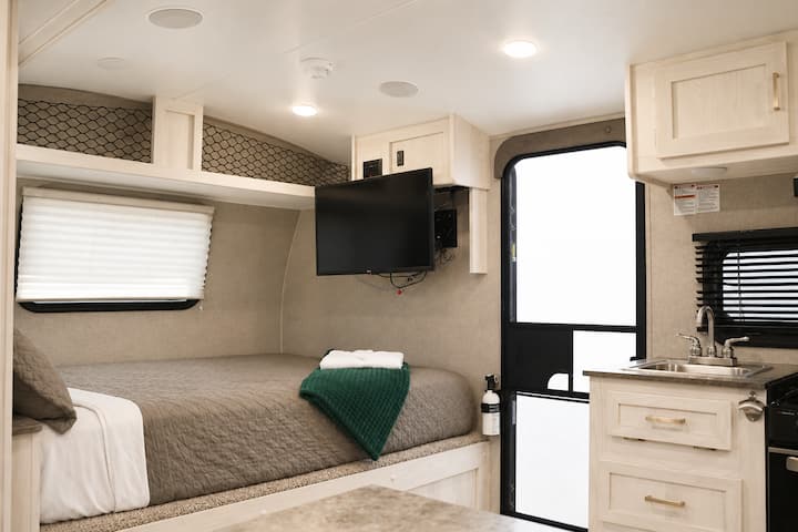 Queen-size bed inside the unit, set in an airy space with plenty of windows right in front—perfect for relaxing and enjoying the view from the comfort of your bed.