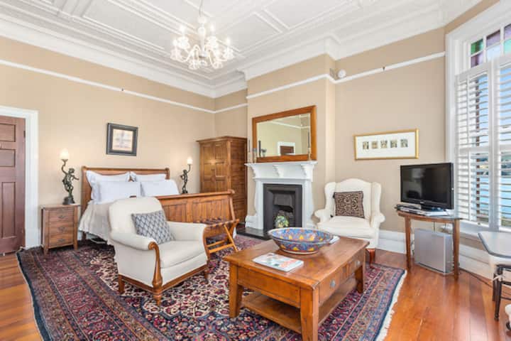 Ლუქს-კლასის საძინებელი სააბაზანოთი, აპარტამენტითა და მოსასვენებელი სივრცით. Ლამაზი მაღალი,  დაპრესილი ლითონის ჭერი . Ნავსადგურის ხედები დუნედინისკენ 