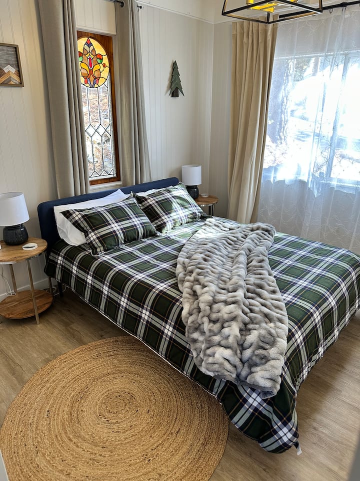 The Bedroom on the Main Floor (Entry/2nd Floor) has a Queen Bed, full closet, and small writing desk.