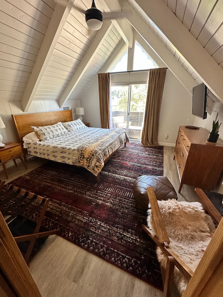 The Primary Bedroom has a King Sized Bed and a Balcony with two club chairs and an Umbrella.

There is also an internet connected TV.