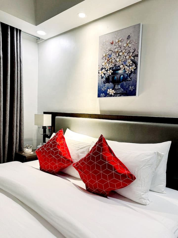 Sink into comfort in this Ritz-inspired bed setup — perfect for restful city nights.

