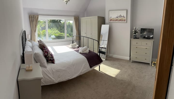 Cama tamaño king con TV inteligente.