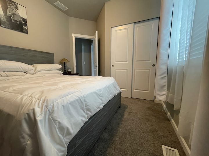 Chumba tulivu cha kulala kilicho na kitanda aina ya queen, kabati la kujipambia na televisheni. Ina bafu lake kamili nje ya mlango. 