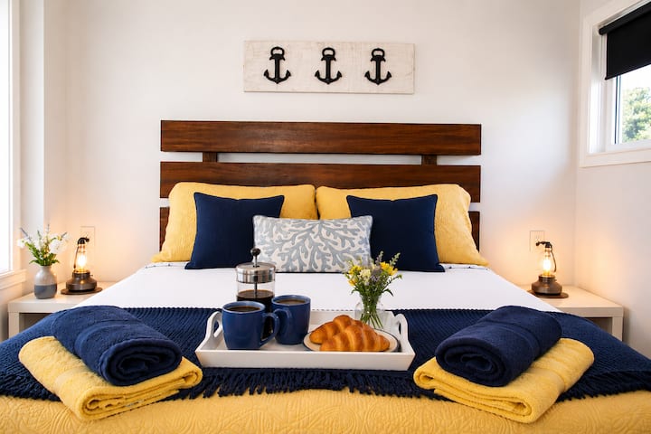Relax and unwind in this coastal-inspired bedroom featuring a luxurious Queen-size bed, quality linens, soft lighting, and charming nautical touches. The perfect retreat to recharge after a day exploring Nova Scotia's stunning coastline.