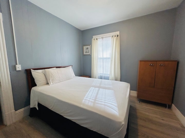 นอนหลับและผ่อนคลายในห้องนอนที่อบอุ่น ห้องนี้มีเตียงขนาดควีนไซส์โต๊ะข้างเตียงลิ้นชักและตู้เสื้อผ้า 2 ลิ้นชัก หน้าต่างบานใหญ่ที่ให้แสงธรรมชาติและมีม่านบังแสงเพื่อการพักผ่อนที่ดี 
