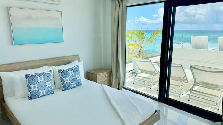 Rooftop Bedroom with Queen bed. A sleek, airy design, calming coastal décor, and direct access to unmatched views, this room is a true island escape. Step onto the rooftop patio and lounge pool right outside your room.