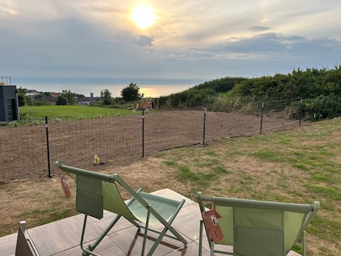 With family or friends by the sea