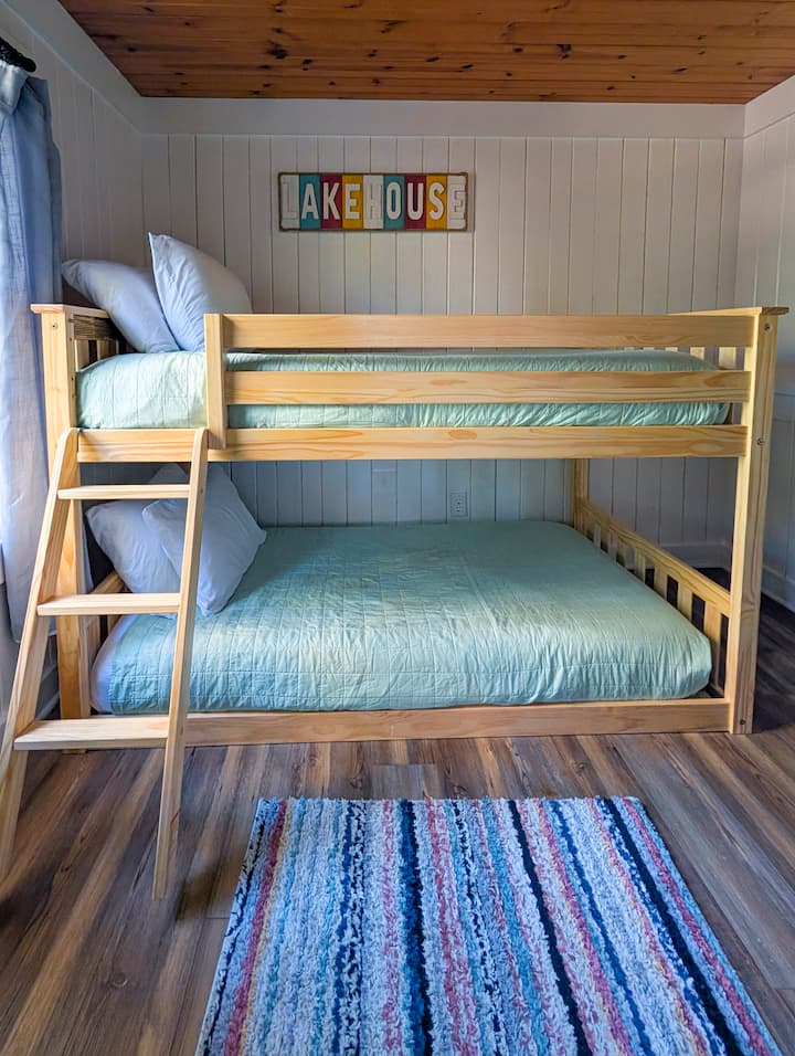 This charming bedroom features a twin over twin bunk bed. The top bunk includes a sturdy railing for added safety.