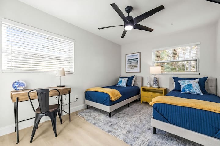 Bedroom 3 | Third bedroom with 2 twin beds, dedicated workspace, smart TV, and ceiling fan.