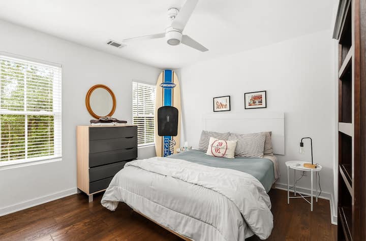 Bright surf-inspired bedroom with natural light and cozy modern touches