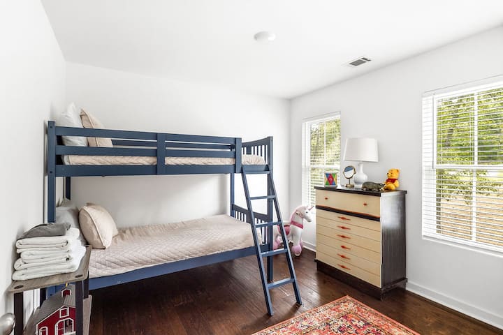 Bright bunk room with natural light, playful touches, and guest-ready comfort