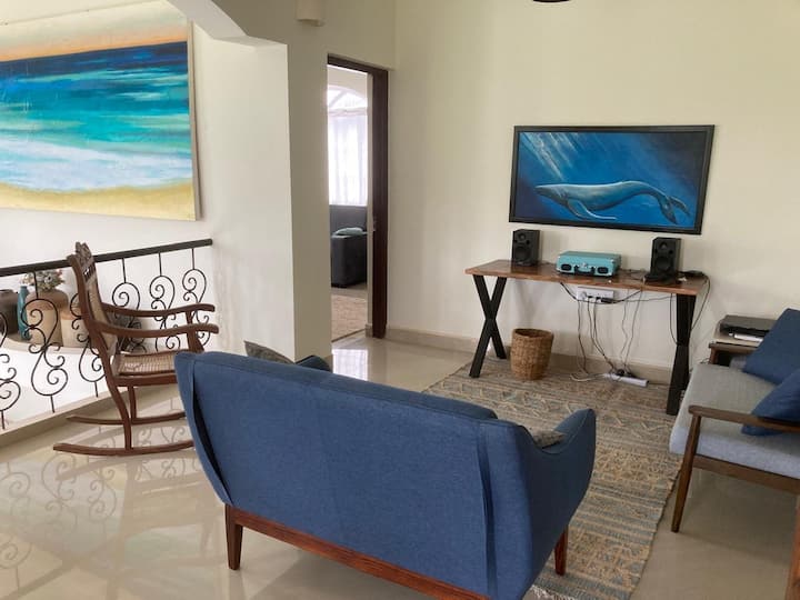 This lounge is between the two upstairs guest rooms. On this floor there is a balcony with a swing, “Jonah and the Whale” painting, the turntable, the keyboard which overlooks the paddy field. Feel free to sing to the water buffalos and birds.