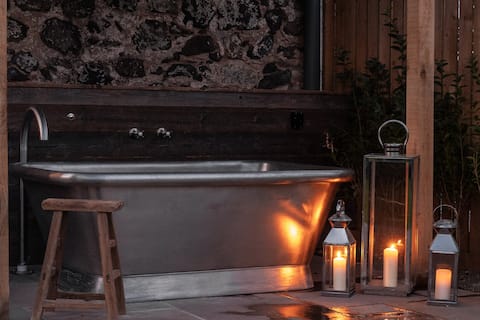 Rustic luxury at the Dairy with outdoor bath.